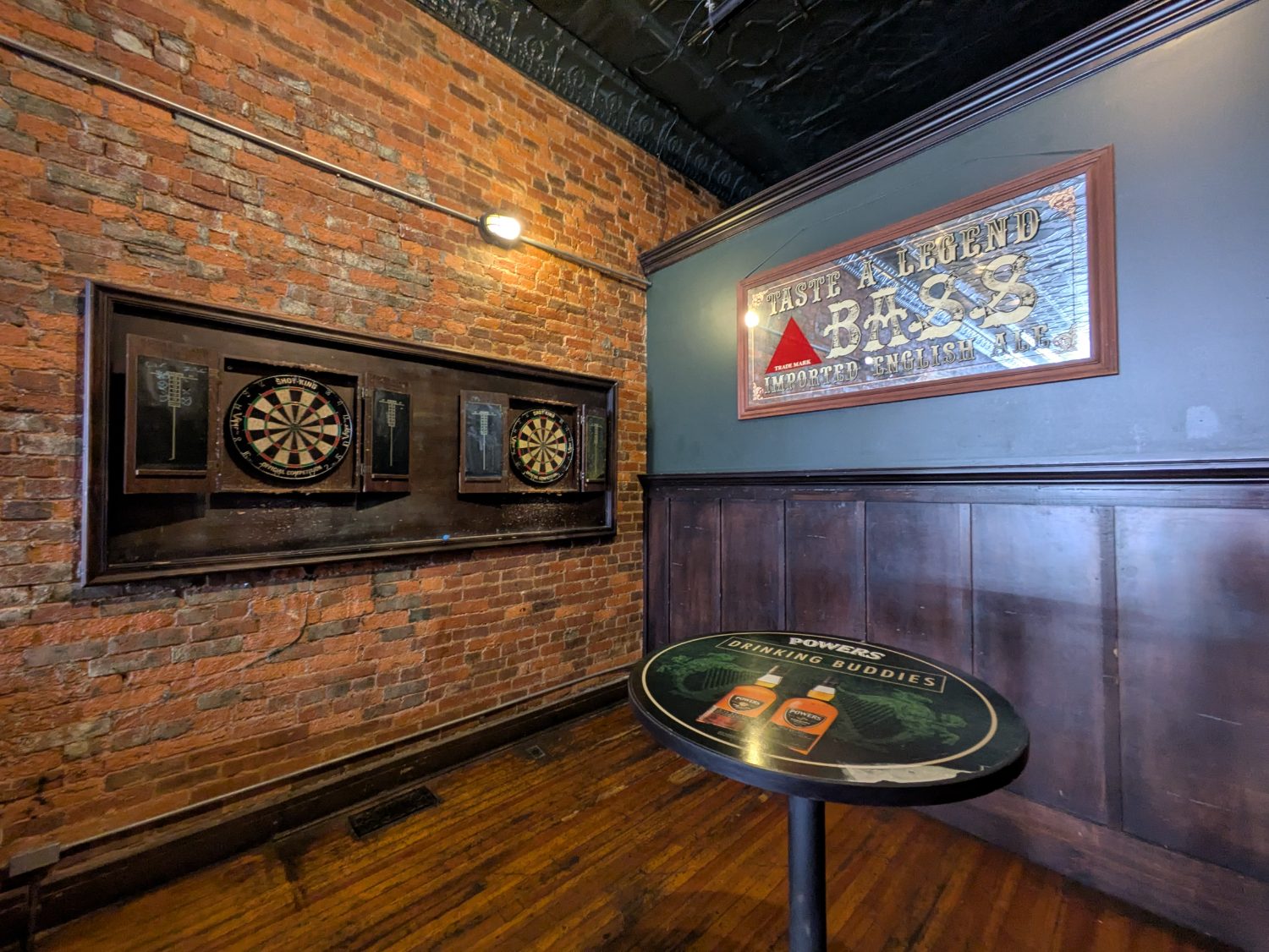 The back room — pool table, neon and worn-in brick