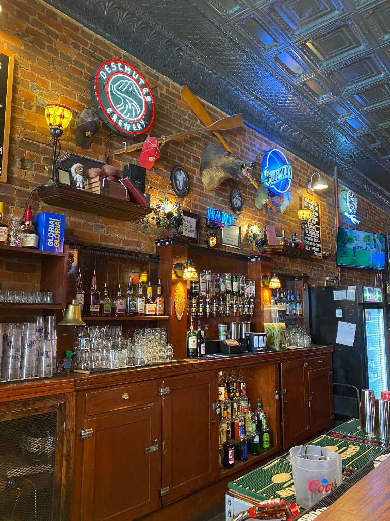Inside Finnegan's Wake — brick walls, neon signs, and the back bar