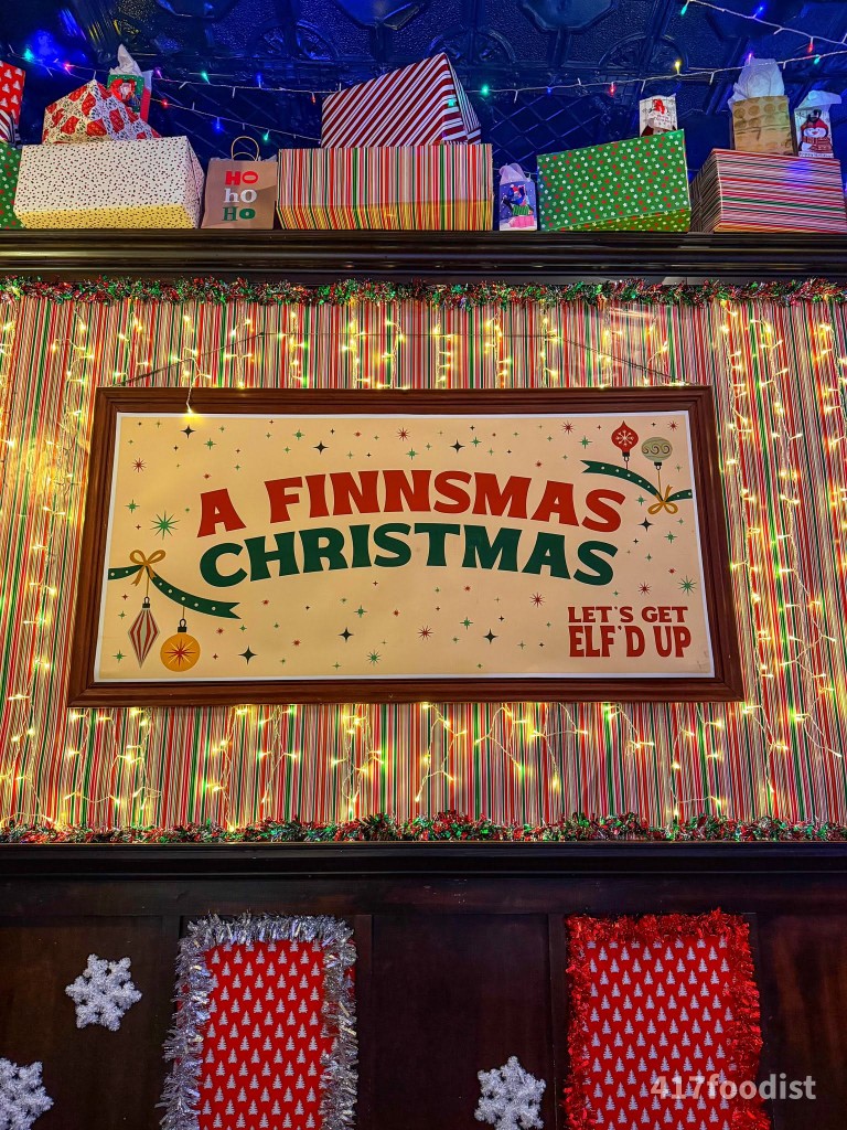 A Finnsmas Christmas sign surrounded by presents