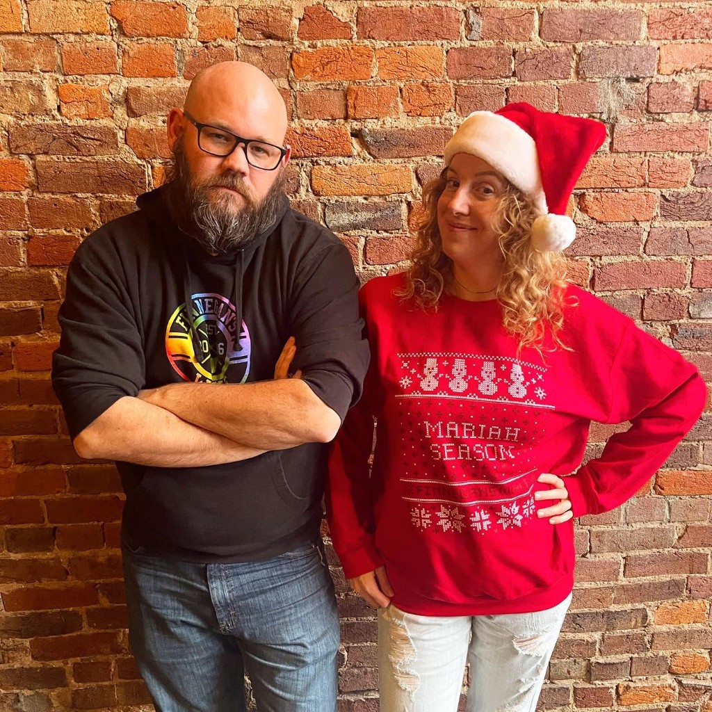 Couple in Mariah Season holiday sweaters at Finnegan's Wake