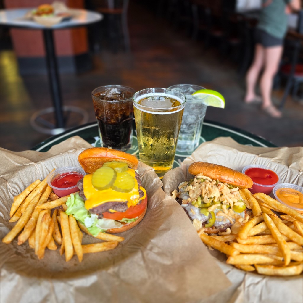 Two burgers with beer and drinks