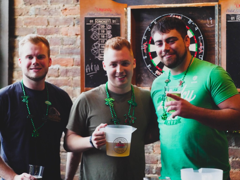 Friends celebrating with pitchers at Finnegan's Wake